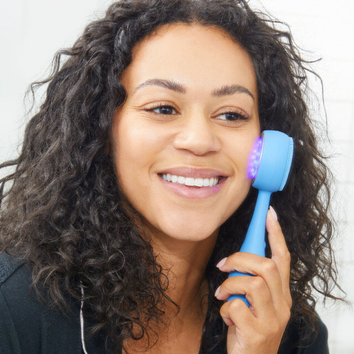 Deklica uporablja napravo PMD Acne Clean na obrazu